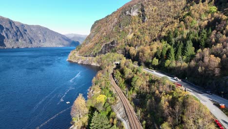 Road-E16-and-Railway-Bergensbanen-together-towards-Stanghelle,-autumn-aerial-Norway