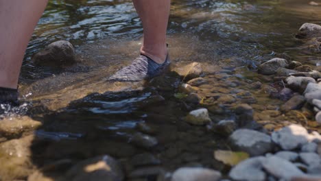 A-Person-Crosses-The-Mountain-Stream,-Closeup-On-The-Feet