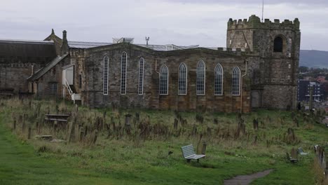 Slow-panning-shot-of-a-historic-cemetery-on-the-hillside-alongside-Whitby-Abbey