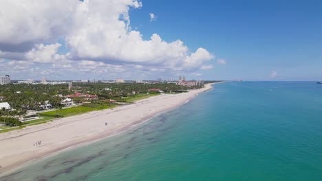 Drone-bird's-eye-view-of-west-palm-beach-skyline-downtown-area-and-beautiful-beach-sand-and-boats-in-water