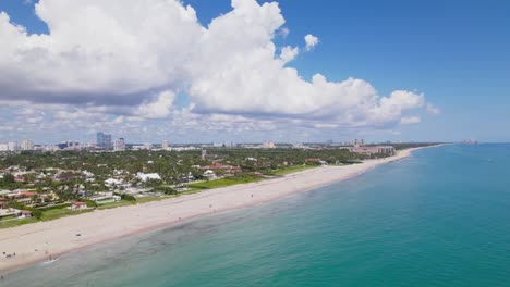Aerial-drone-view-of-west-palm-beach-skyline-downtown-area-and-beautiful-beach-sand-and-boats-in-water