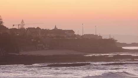 Landscape-vintage-shot-of-a-town-near-the-coast-during-sunset