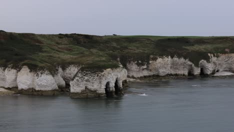Panning-shot-of-white-cliffs-and-beach-on-the-coast-of-England