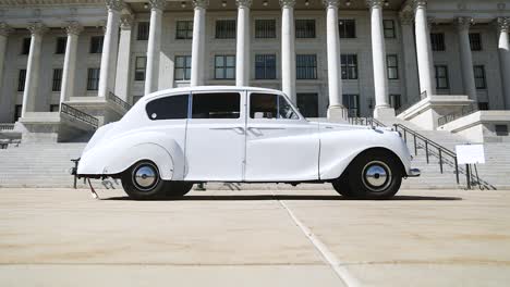 Slow-pan-of-white-Princess-Rolls-Limo-in-front-of-Utah-State-Capitol-Building