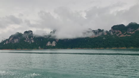 cruising-the-Khao-Sok-National-Park-nature-reserve-in-southern-Thailand-with-foggy-mountains-landscape