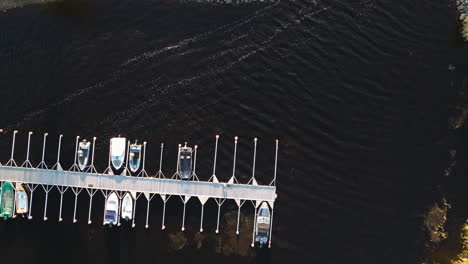 Vista-Superior-De-Los-Barcos-Amarrados-En-El-Muelle-Con-Un-Lago-De-Aguas-Tranquilas-En-Suecia-Durante-El-Otoño