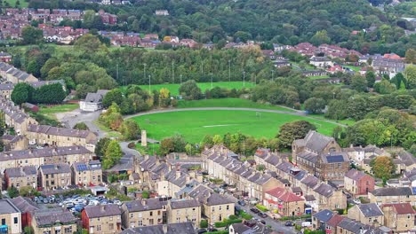 Iconic-apartment-flats-around-grassy-football-pitch-in-Huddersfield-England