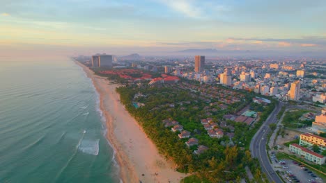 Stunning-Aerial-Shot-Of-Beachfront-Resorts-In-Da-Nang-Vietnam-During-Colorful-Sunset