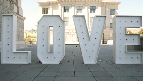 Big-white-love-prop-letter-wedding-decoration-in-front-of-sunny-building