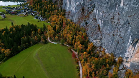 Aerial-view-following-a-trail-to-a-town-near-Lake-Toplitz,-fall-day-in-Austria