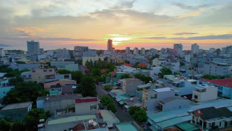 4K-Aerial-Flying-Over-Vietnamese-City,-Da-Nang,-Vietnam-During-Golden-Hour-Sunset