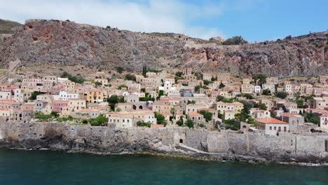 Monemvasia-village-houses-in-the-municipality-of-Laconia,-Greece,-located-on-a-tied-island-off-the-east-coast-of-the-Peloponnese,-Aerial-view