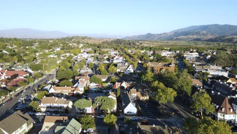 Witness-the-enchanting-transformation-of-Solvang-Valley-as-the-town-basks-in-the-warm-embrace-of-the-sunset,-captured-from-an-aerial-perspective