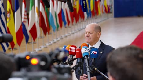 Chancellor-of-Germany-Olaf-Scholz-giving-a-statement-at-the-EU-summit-in-Brussels,-Belgium---Cinematic-medium-shot