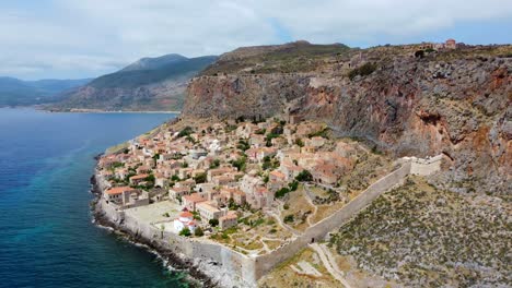 Monemvasia-village-houses-in-the-municipality-of-Laconia,-Greece,-located-on-a-tied-island-off-the-east-coast-of-the-Peloponnese,-Aerial-view