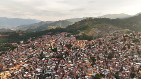 Drone-shot-over-hills-full-of-ghetto-dwellings-in-Commune-13,-sunset-in-Colombia