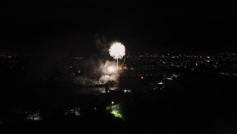 Aerial-shot-of-large-golden-fireworks-being-set-off-on-guy-fawkes-night