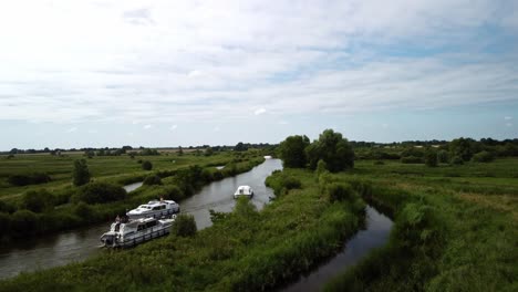 Aerial-Drone-video-of-the-a-couple-of-boats-along-the-rural-River-Yare-on-the-Norfolk-Broads