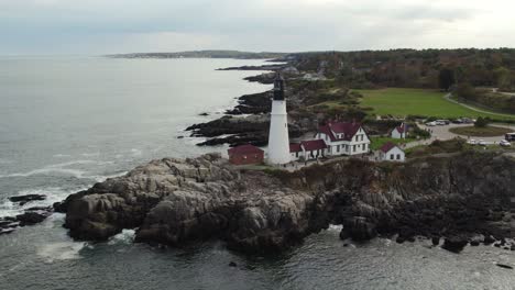 Aerial-Shot-Of-Historical-Lighthouse-On-A-Rocky-Coastline