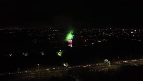 Aerial-dolly-shot-of-fireworks-being-set-off-on-bonfire-night-in-the-UK