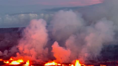Cinematic-long-lens-booming-down-shot-of-the-glowing-lava-lake-at-Kilauea-as-the-volcano-erupts-at-sunset-on-the-first-day-of-activity-in-September-2023-on-the-island-of-Hawai'i