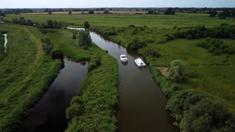Aerial-Drone-4k-Footage-of-Boats-passing-each-other-in-a-section-of-the-River-Yare,-Norfolk-Broads,-Norfolk