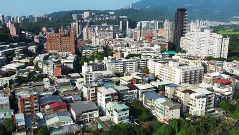 Drone-View-of-Guandu's-Skyline-and-Hills-in-Taipei,-Taiwan