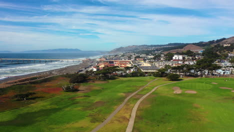 Aerial-view-approaching-the-city-of-Pacifica,-golden-hour-in-California,-USA