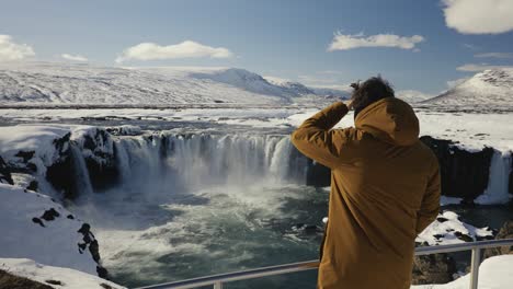 Man-come-to-metal-safety-barrier-near-Godafoss-waterfall-sightseeing-area