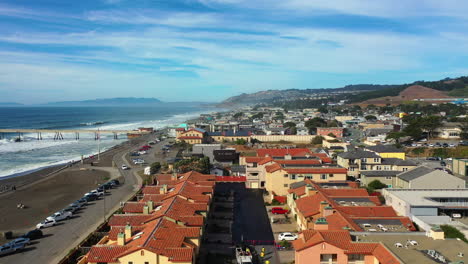 Aerial-view-over-the-cityscape-of-Pacifica-city,-sunny-evening-in-California,-USA
