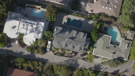 4k-drone-cork-screw-pullout-shot-of-backyard-swimming-pools-in-the-Hollywood-Hills