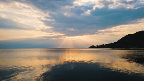 Timelapse-of-clouds-and-sunrays-over-the-lake