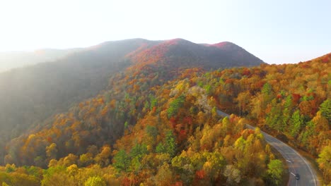 Drone-slowly-flying-above-the-North-Georgia-mountains-full-of-Fall-colors-at-sunset