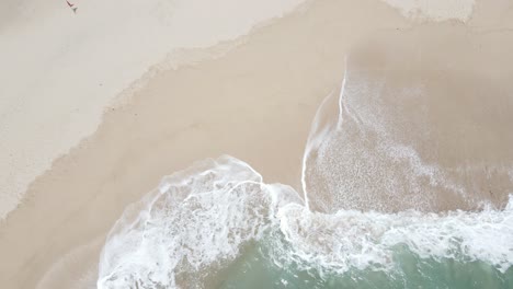 aerial-view-or-seen-from-above-of-the-waves-and-white-sand-on-Klayar-beach,-Pacitan,-Indonesia