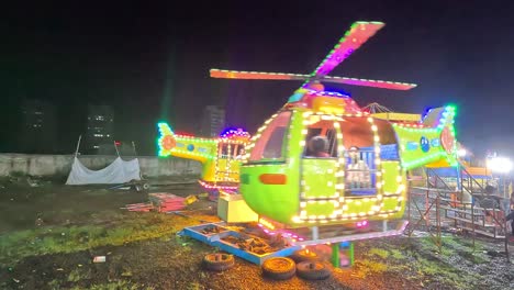 Cinematic-view,-little-kids-enjoying-Kids-Helicopter-Ride-at-night