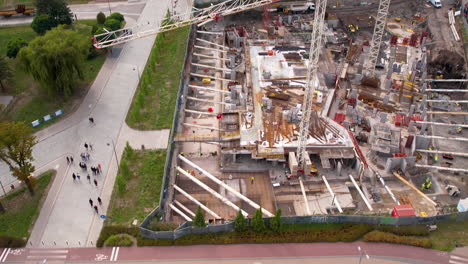 Aerial-tilt-up-reveals-high-rise-construction-cranes-in-city-center