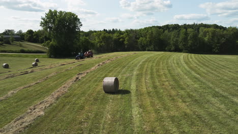 Field-Of-Round-Hay-Bales---Wheel-Tractor-Machine-Baling-Hay-Straw