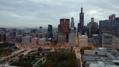Aerial-view-over-the-Grant-park-toward-high-rise-of-Loop,-fall-evening-in-Chicago