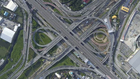 Aerial-View-of-Highway-Road-Interchange-with-Busy-Urban-Traffic-Speeding-on-Road