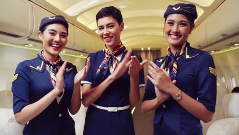 Cabin-crew-clapping-hands-in-airplane