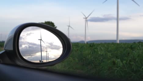 Progressive-ideal-of-wind-turbine-reflected-in-side-mirror-of-electric-vehicle.