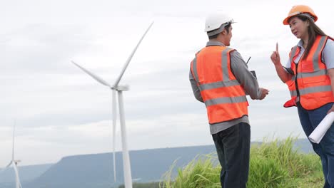 Progressive-concept-of-engineers-working-in-the-wind-farm-atop-of-the-mountain.