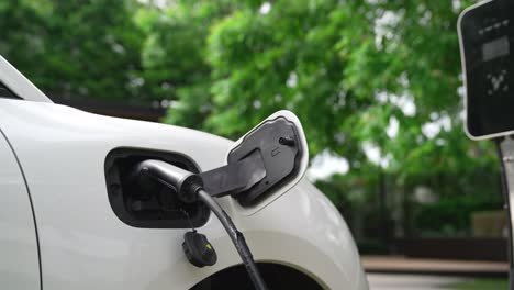 Closeup-progressive-concept-of-electric-car-being-charged-at-charging-station.