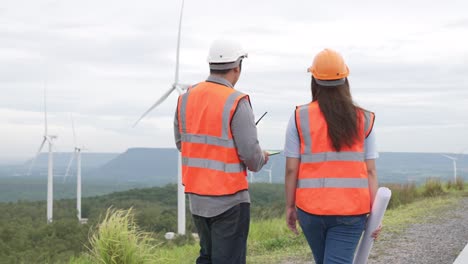 Progressive-concept-of-engineers-working-in-the-wind-farm-atop-of-the-mountain.
