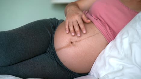 Happy-pregnant-woman-and-expecting-baby-at-home.