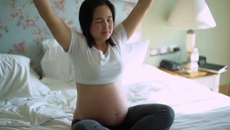 Happy-pregnant-woman-and-expecting-baby-at-home.