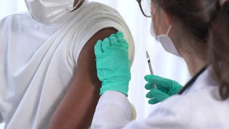 Young-man-visits-skillful-doctor-at-hospital-for-vaccination