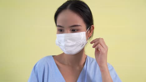 Young-Asian-woman-take-off-face-mask-removing-from-face