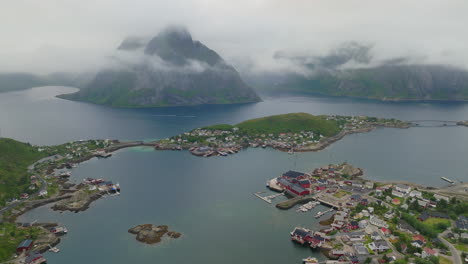 Misty-clouds-hang-below-coastal-sea-cliffs-above-Reine-Lofoten-Norway-in-summer