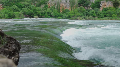 Clear-water-in-wave-form-with-algae-in-the-Krka-park